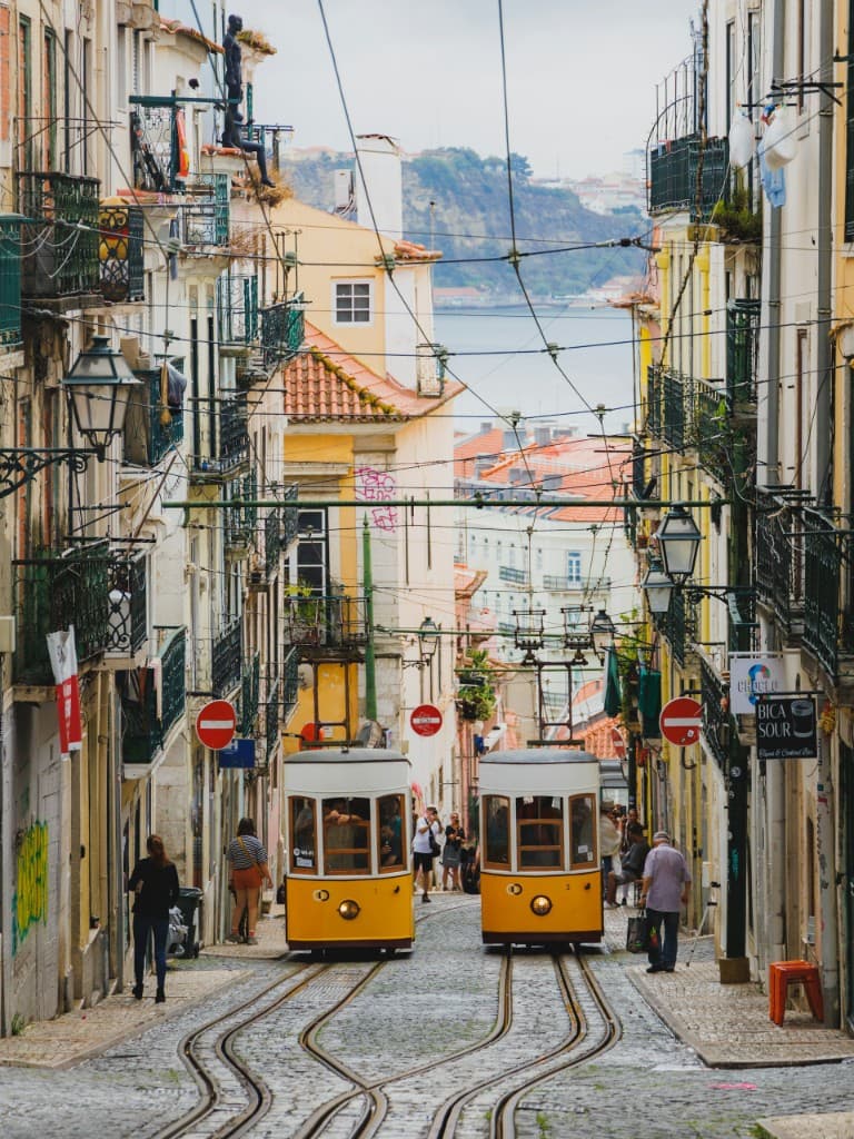 Yellow trams on a steep Lisbon street