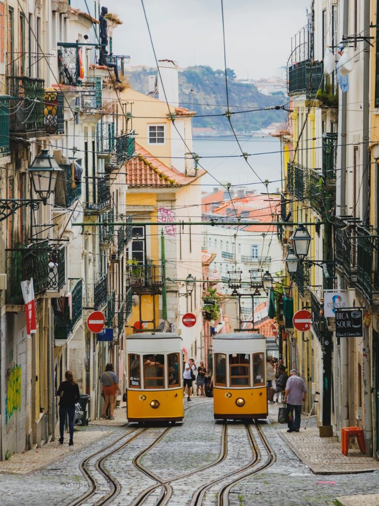 Yellow trams on a steep Lisbon street
